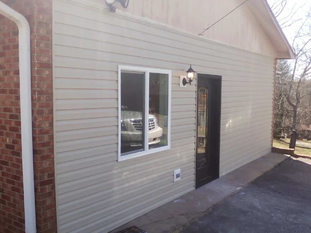 New vinyl siding and entry door on a room addition in Hollsopple